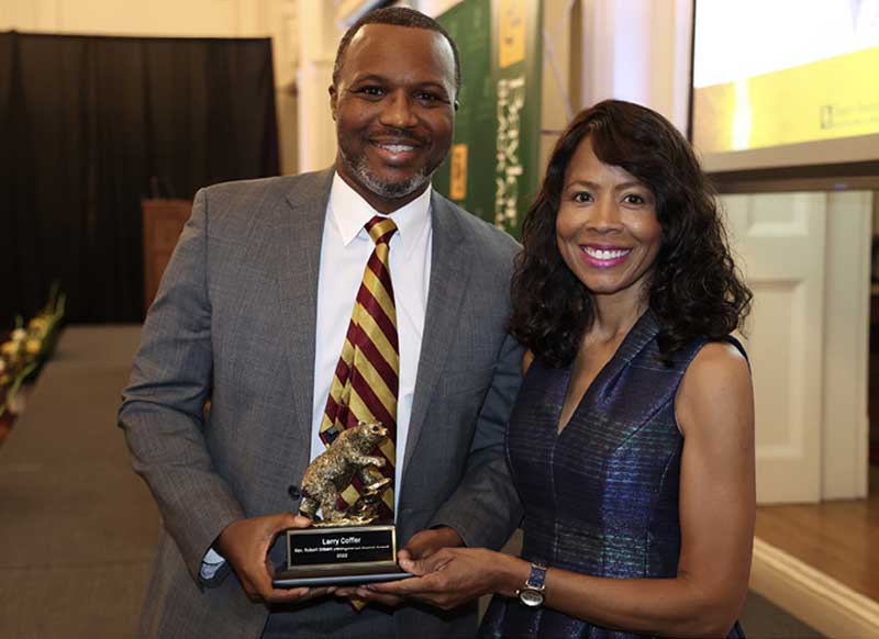 Monica Anderson B.A. 84 (R) Presents The Distinguished Black Alumni Award to Larry W. Coffer II (L)