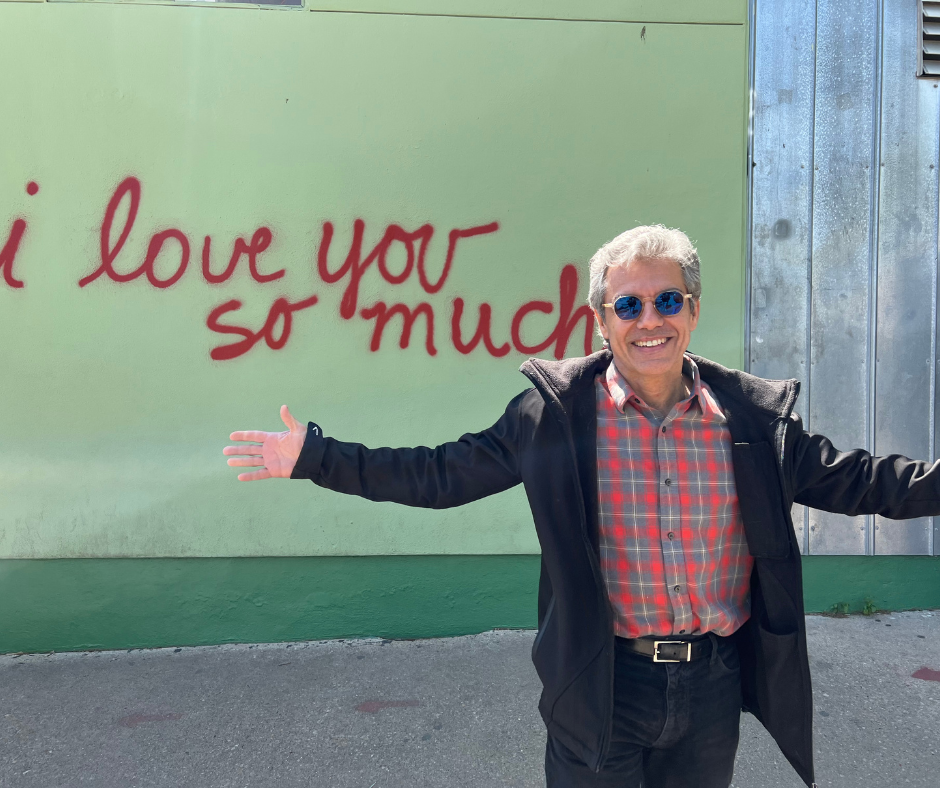 Dr. Marco Chalaby (BA ’87, MA ’89) in front of "I love you so much sign"
