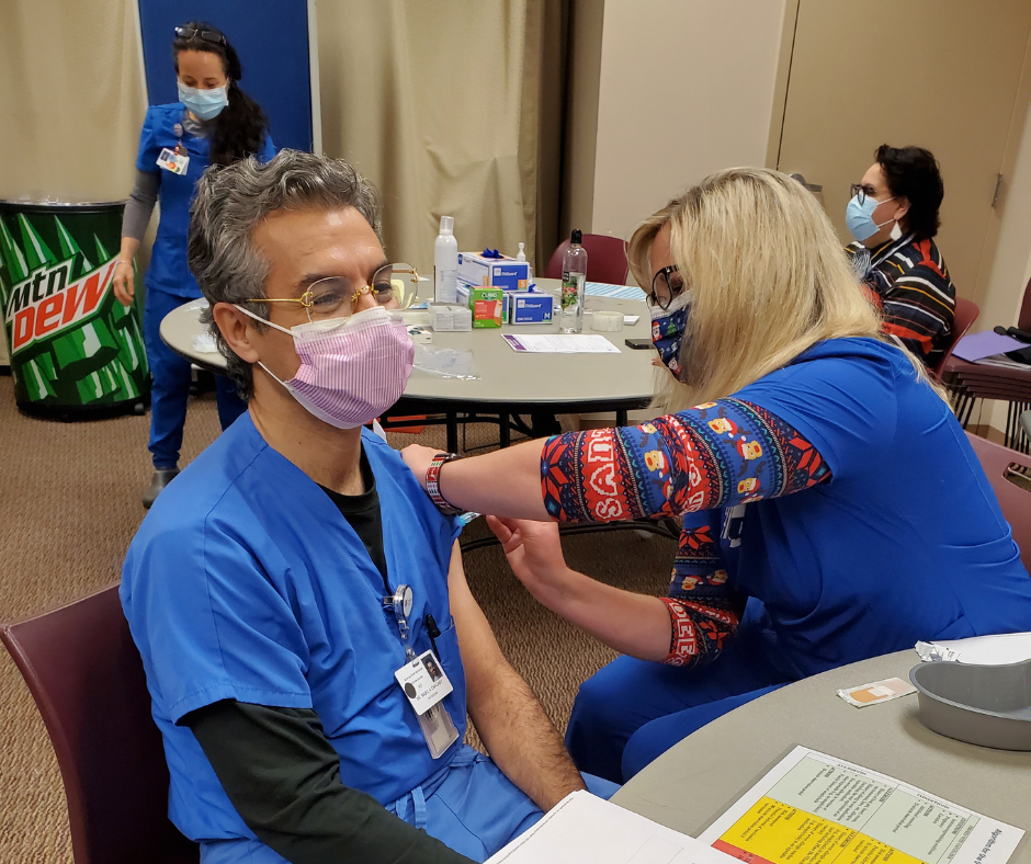 Dr. Marco Chalaby (BA ’87, MA ’89) getting immunizations