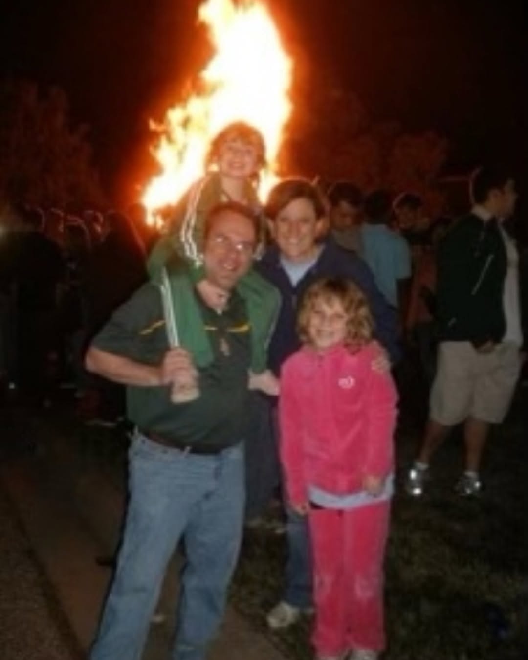 Anna Johnson as a young girl with her family at a Baylor Homecoming bonfire