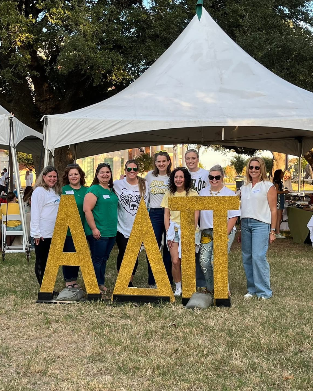 Shannon Seale poses with a group of women behind giant ADPI letters in the greek alphabet at a tailage