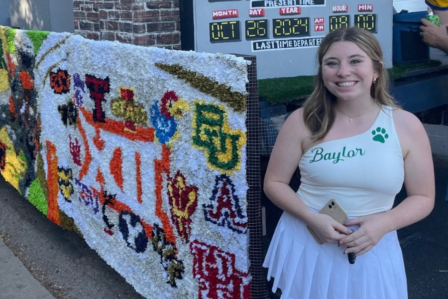 Anna Johnson stands next to Homecoming float as 2024 Tridelt Float Chair