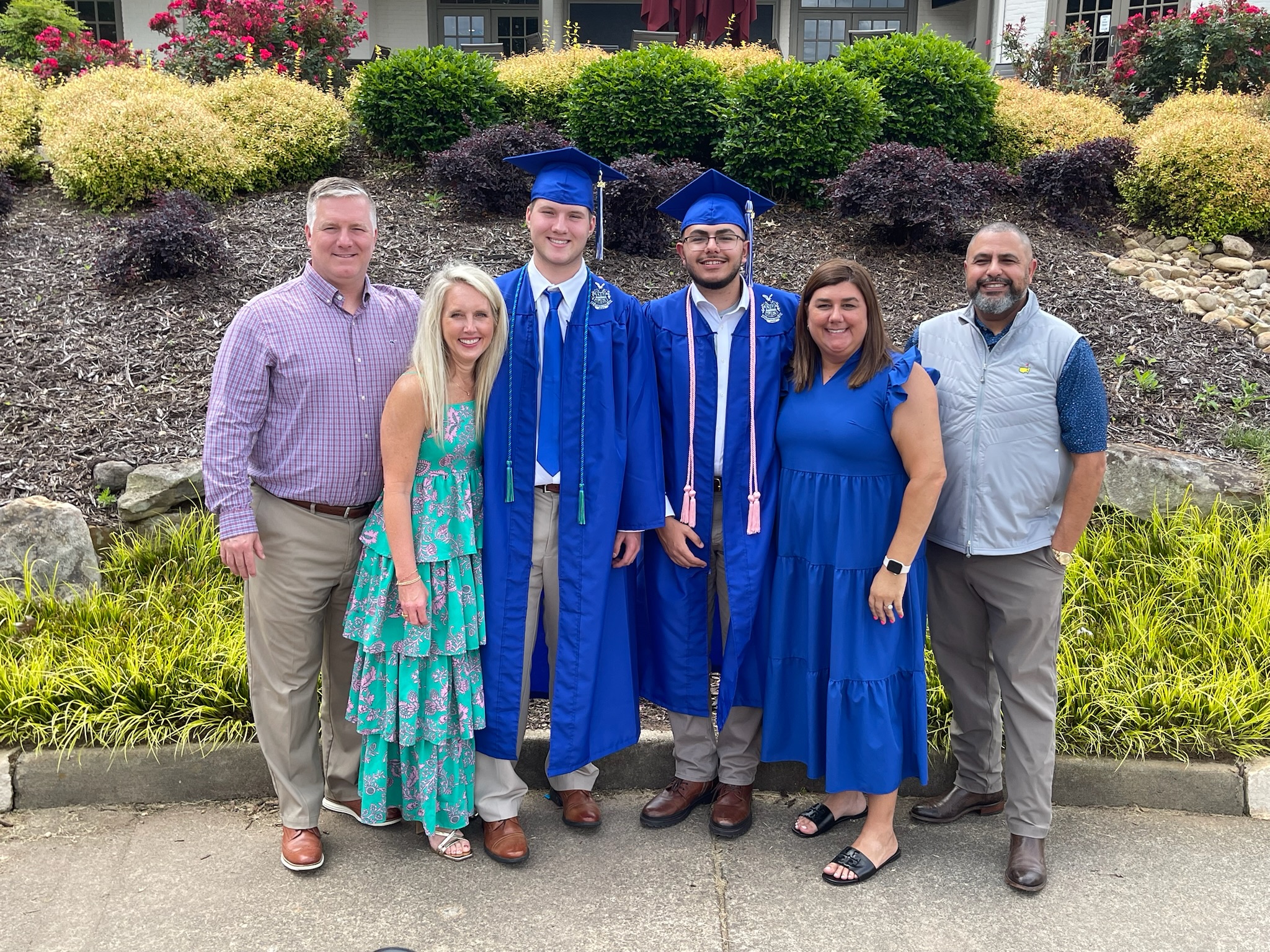Hosni and Christian families pose with their sons at their highschool graduation