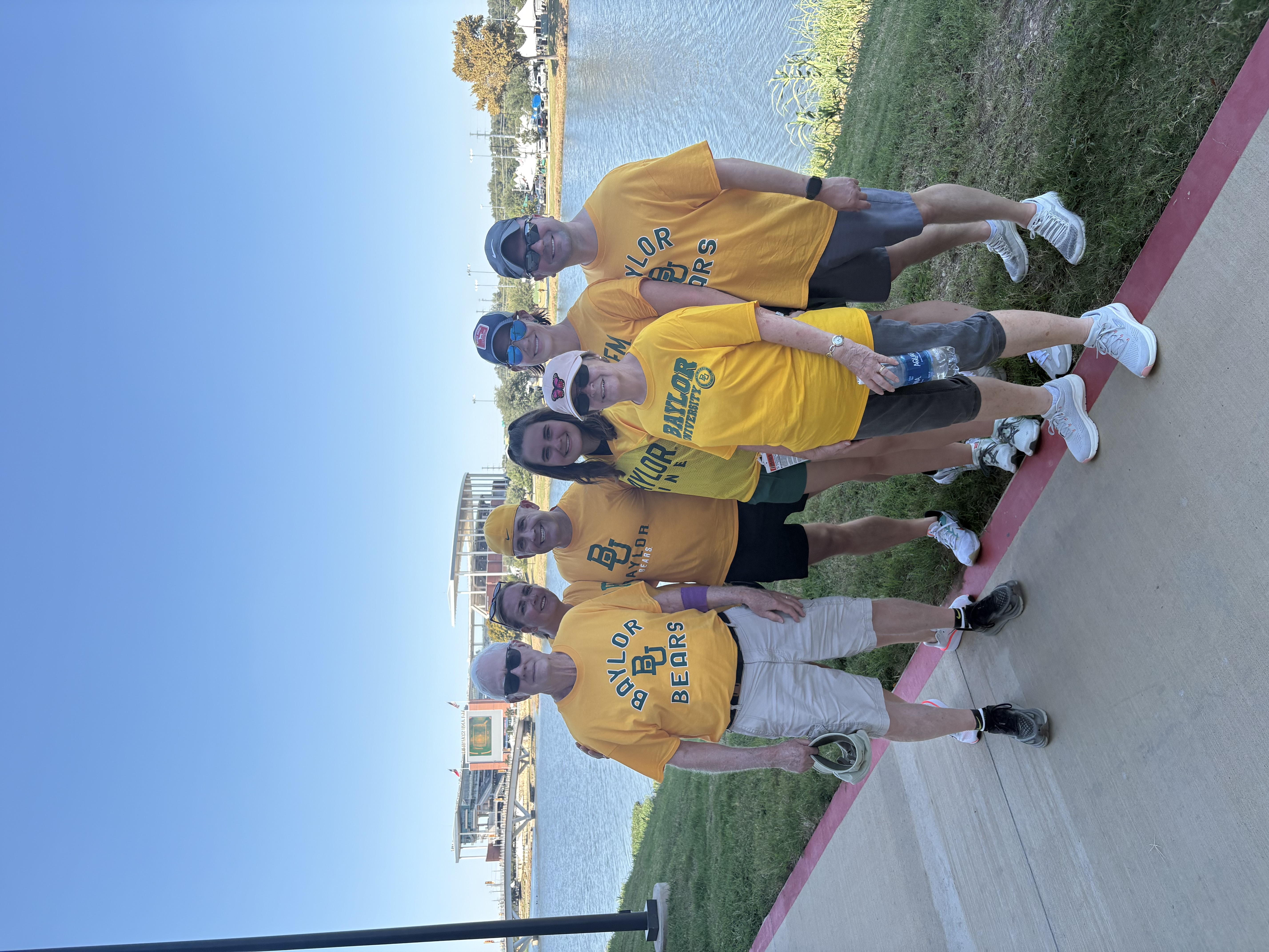 Family wearing Baylor T-shirts standing in front of McLane Stadium