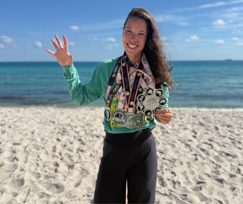 Ashleigh Tran, Baylor alum on a beach with awards 