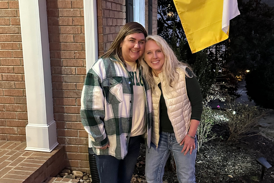 Amanda Hosni (left) and Amanda Christian (right) pose in front of Baylor flag
