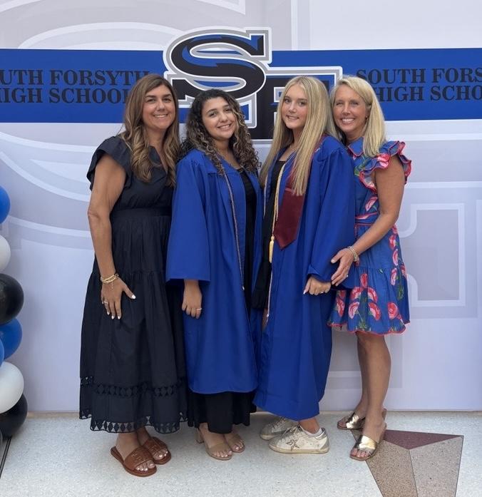 Amanda Hosni and Amanda Christian posing with their daughters at their high school graduation